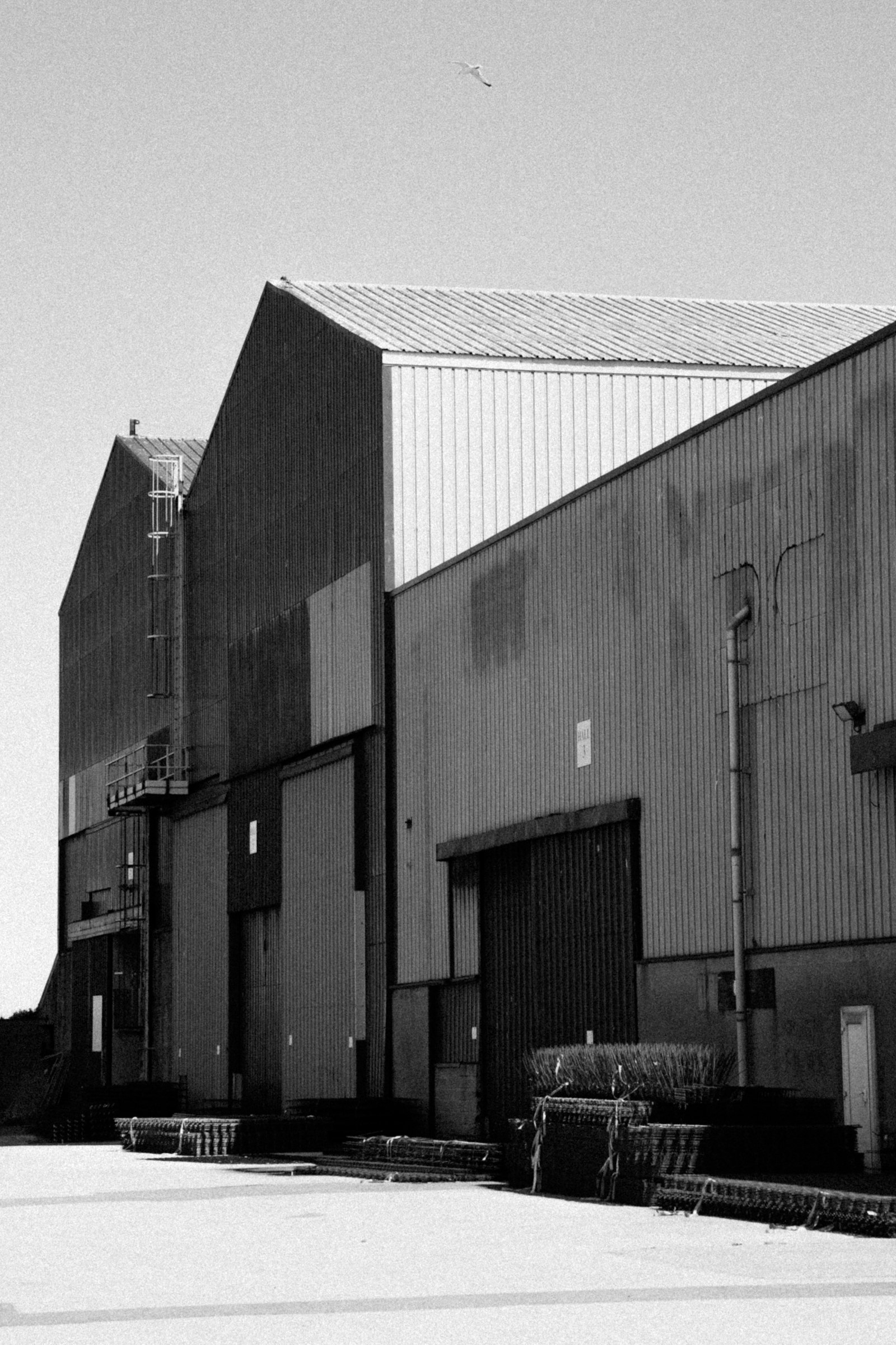 Industrial warehouse with corrugated metal siding and loading doors.